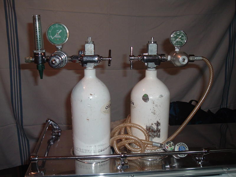 Float type oxygen regulator on the left and Positive Pressure device on the right.