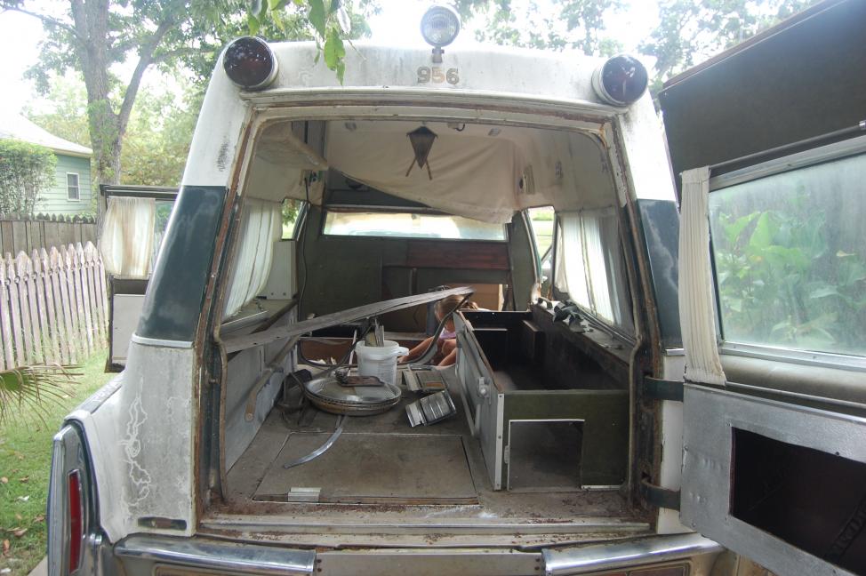 Interior (Note that someone has removed the medic cabinets, etc.  The trim is in the bench cabinet.)  My daughter helping with the clean up on day one
