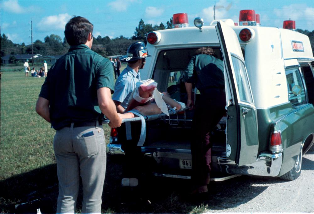 Loading a Pontiac during an exercise with the assistance of Lafayette Fire Department.  The first "uniform" was green shirt with dress slacks from the